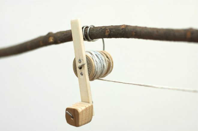 Usando un pezzo di filo, avvolgere la bobina sul ramo e attaccare una maniglia ad esso
